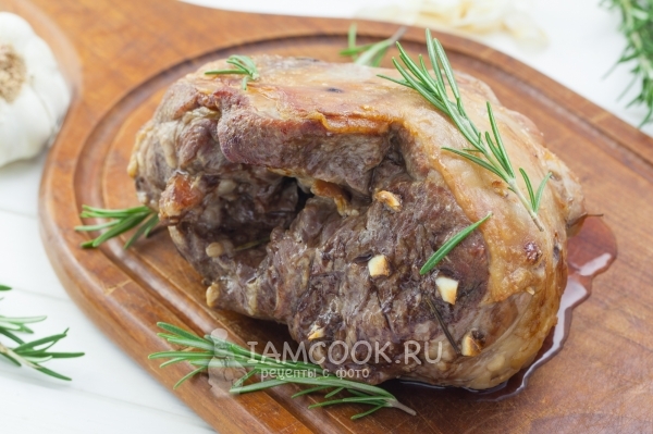 Photo of lamb with garlic and rosemary in the oven