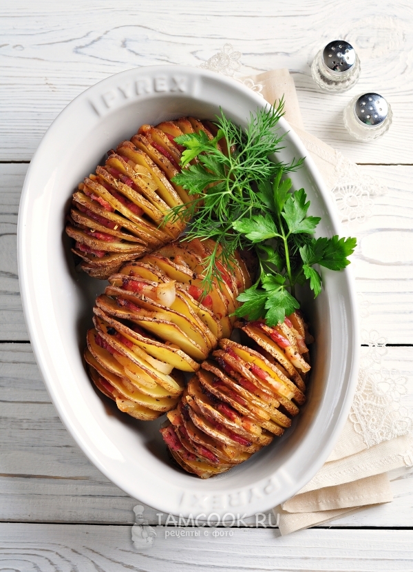 صورة لأكورديون البطاطا ، خبز مع لحم الخنزير المقدد وأعشاب عطرية