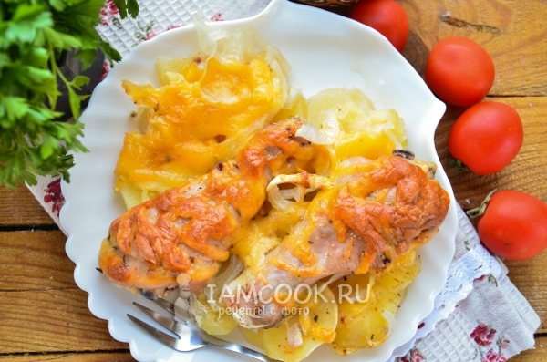 A potato recipe with chicken drumsticks and cheese in the oven