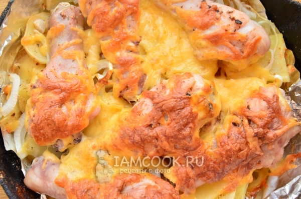 Potato with chicken drumsticks and cheese in the oven