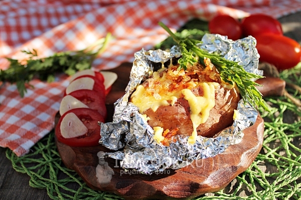 Photo of potatoes with cheese in foil in the oven