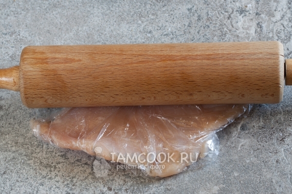 Roll the chicken fillet with a rolling pin