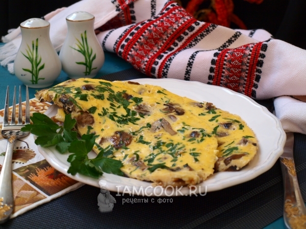 Omelette recipe with mushrooms in a frying pan