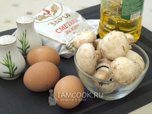 Ingredients for omelette with mushrooms in a frying pan
