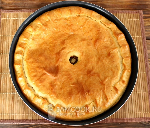 Photo of a pie with cabbage and mushrooms