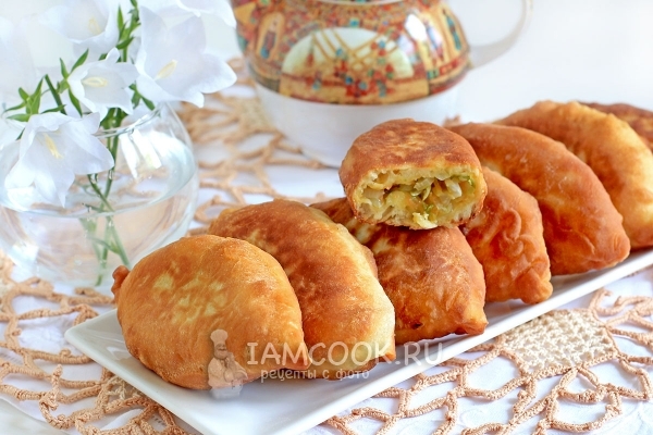 Photo of fried pies with cabbage on yogurt (in a frying pan)
