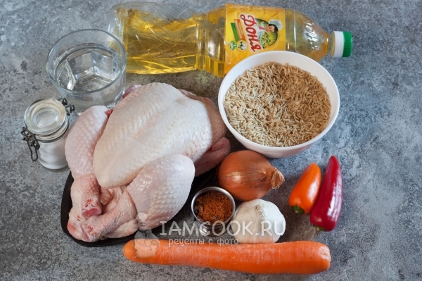 Ingredients for pilaf from brown rice with chicken in cauldron