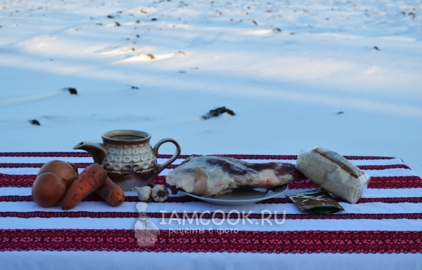 Ingredients for pilaf in cauldron at the stake