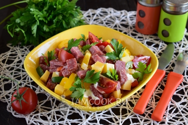 Photo of a salad with smoked sausage and tomatoes